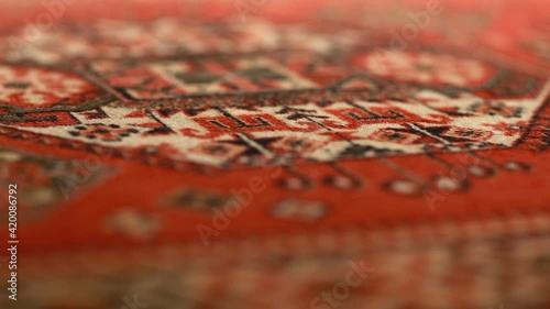 persian carpet beautiful ornament soft woolen texture close-up, shallow depth of field, motion, abstract background