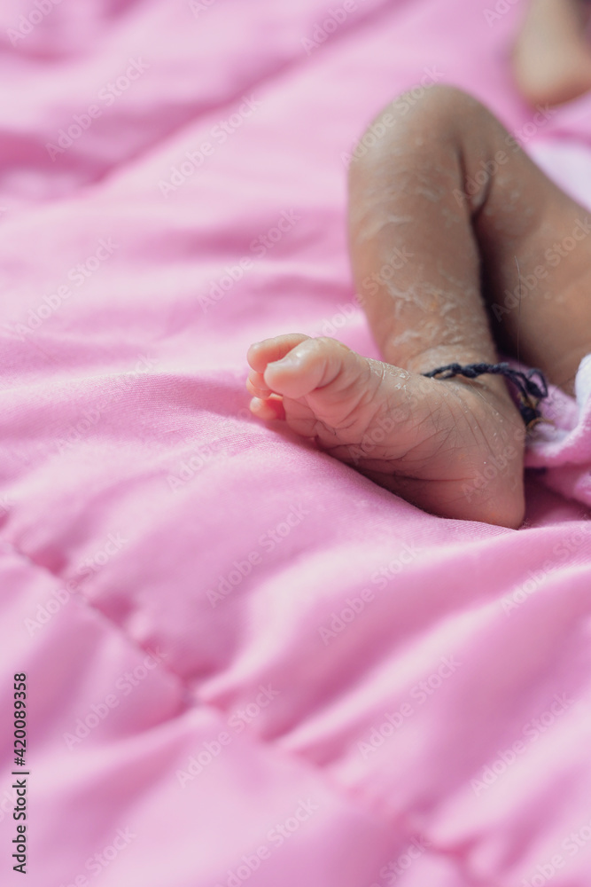 A little child is laughing while sleeping, sometimes crying