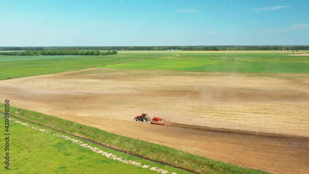 4K Aerial View Tractor With Seed Drill Machine Sowing The Seeds For Crops In Spring Season. Beginning Of Agricultural Spring Season. Countryside Rural Field Landscape. Cinematic Shot 4K Aerial View Tractor With Seed Drill Machine Sowing The Seeds For Crops In Spring Season. Beginning Of Agricultural Spring Season. Countryside Rural Field Landscape. Cinematic Shot