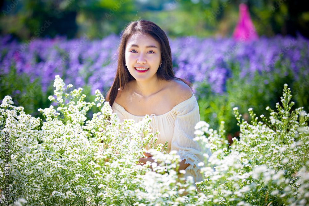 Beautiful asian girl Taking pictures in a flower farm. Happily in Chiang Mai, Thailand Beautiful asian girl Taking pictures in a flower farm. Happily in Chiang Mai, Thailand