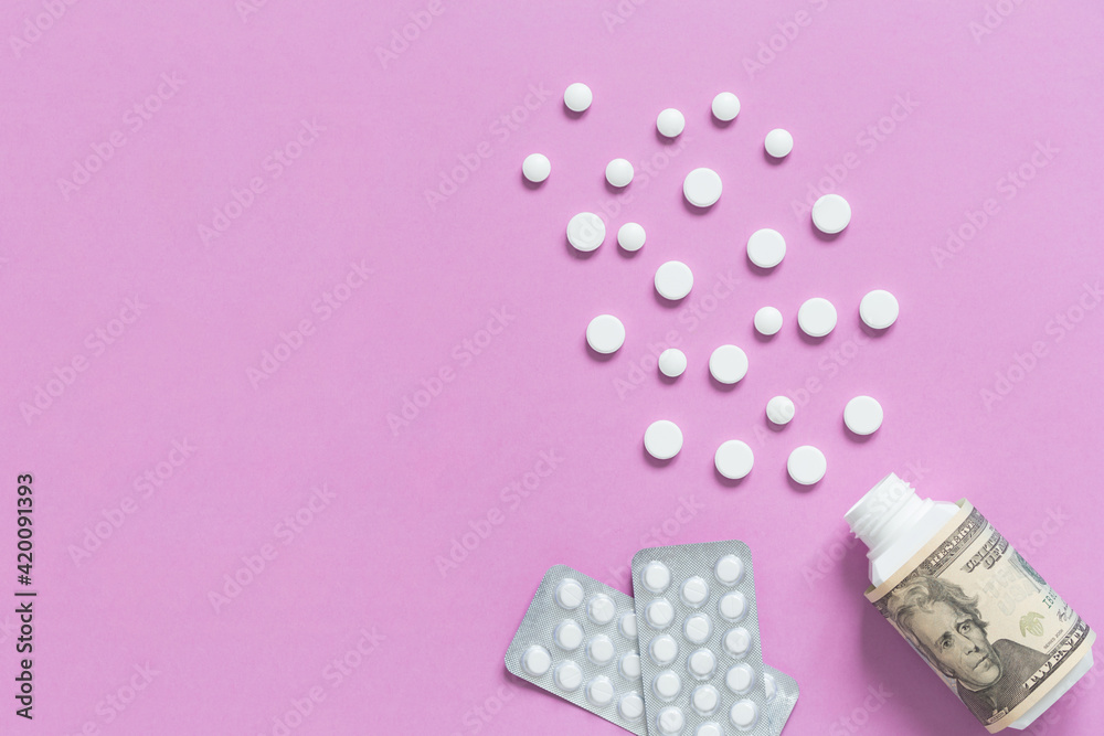 Medical bottle with dollars and packagings with pills. The concept of insurance medicine, high cost of drugs. Isolated on a pink background. Medical bottle with dollars and packagings with pills. The concept of insurance medicine, high cost of drugs. Isolated on a pink background.