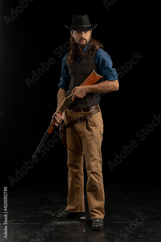 Cowboy with guns. Studio shooting
