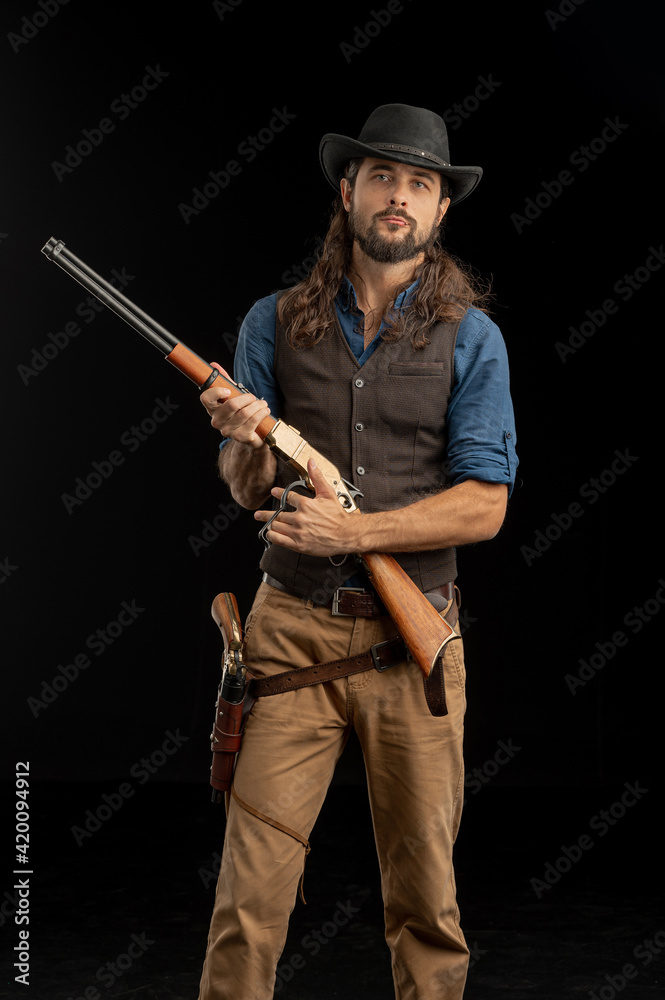 Cowboy with guns. Studio shooting Cowboy with guns. Studio shooting