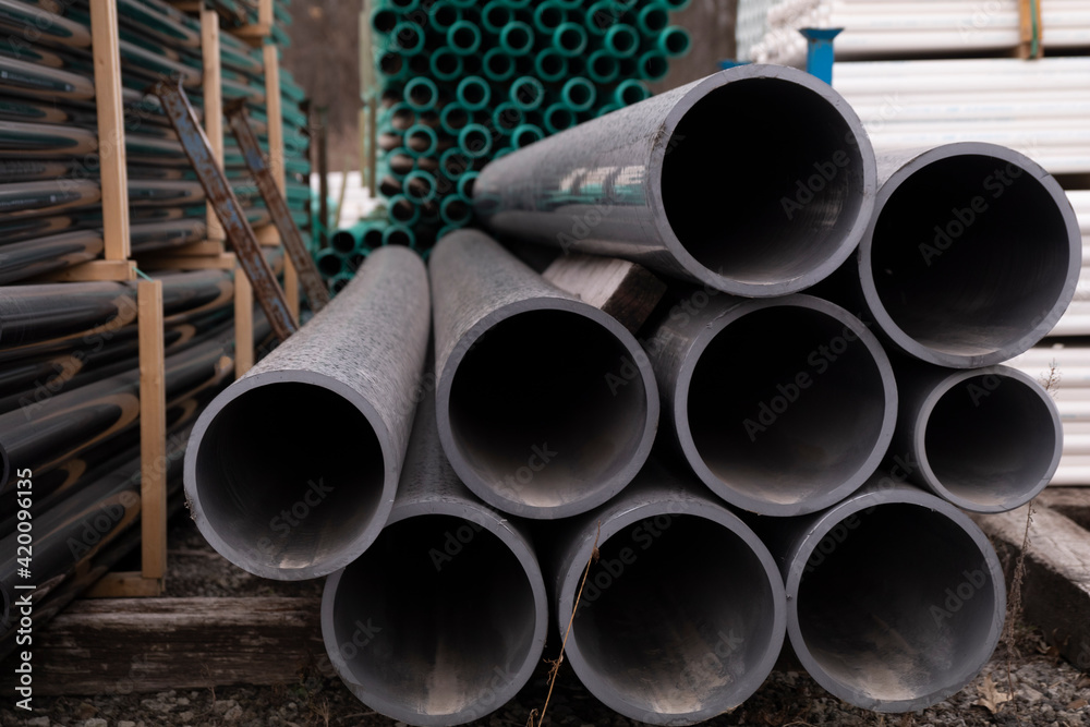 PVC pipes or tubes in different sizes for sewer or construction or industrial or manufacturing or water or engineering or equipment or material purposes create an abstract appearance PVC pipes or tubes in different sizes for sewer or construction or industrial or manufacturing or water or engineering or equipment or material purposes create an abstract appearance