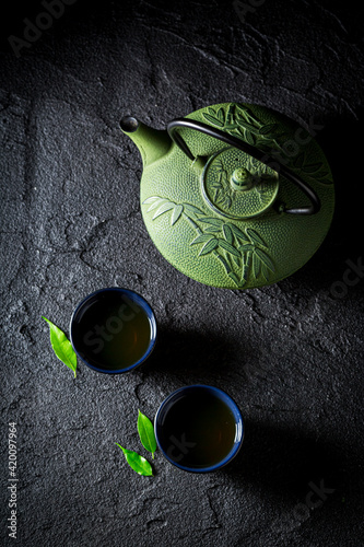 Aromatic green tea on black table. Chinese cuisine.