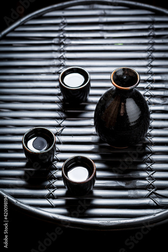 Drink sake in Asian restaurant on table. Japanese cuisine.