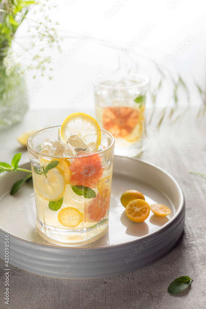 Glass of cool lemonade citrus summer fresh drink with orange, kumquat, lemon and tangerine Glass of cool lemonade citrus summer fresh drink with orange, kumquat, lemon and tangerine