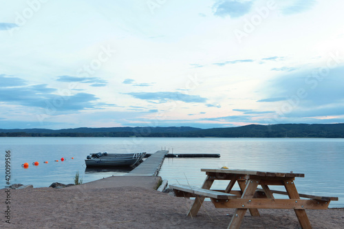 Picnic table and wooden dock on the lake in Sweeden.