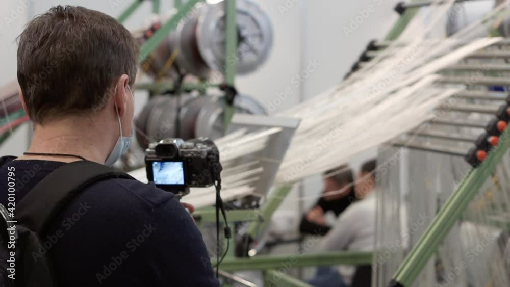 A photographer takes pictures of production equipment. A photographer takes pictures of production equipment.