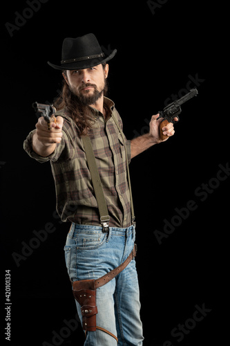 Cowboy with guns. Studio shooting