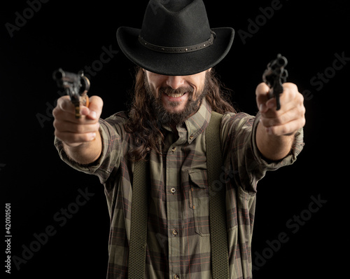 Cowboy with guns. Studio shooting