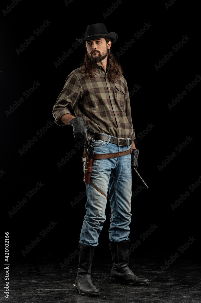 Cowboy with guns. Studio shooting