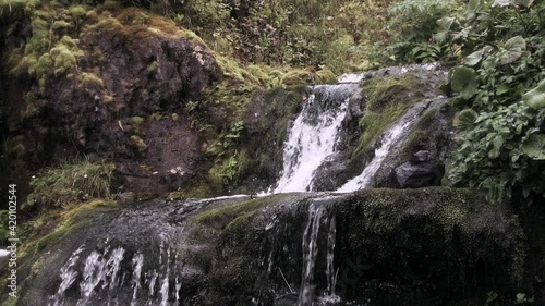 Waterfall flows down steps of cliff