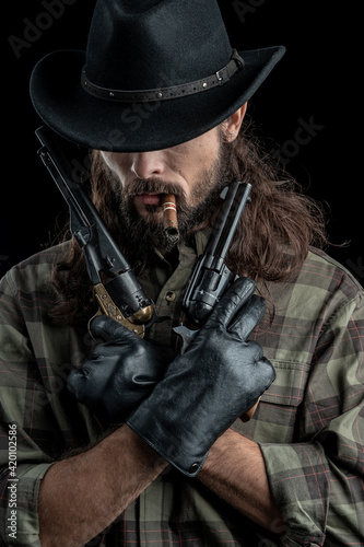 Cowboy with guns. Studio shooting