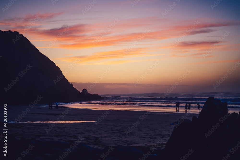 Evening scenery of dark dusk with sky and horizon over ocean foaming waves, scenic view of seaside and sandy shore in morning sunrise sky and clouds