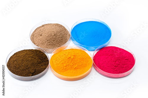 фотографія colored pigments, iron oxides used as a dye, in orange, blue and pink
