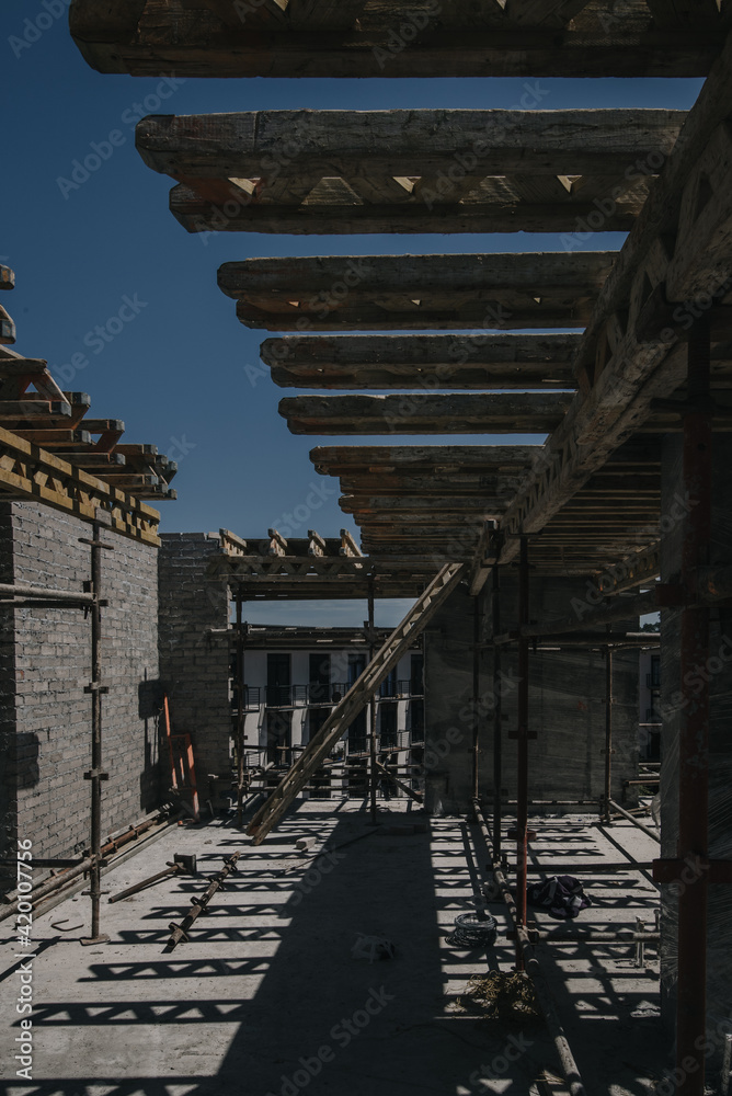 Construction site of multi-storey building with concrete slabs and columns. Men at work . Construction site of multi-storey building with concrete slabs and columns. Men at work .