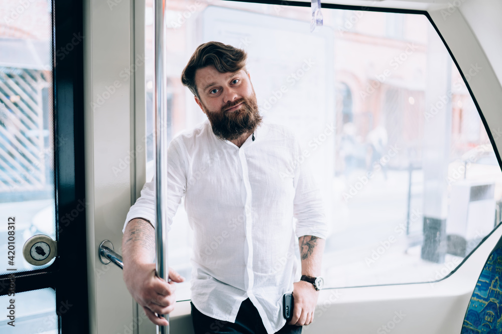 Serious man standing in modern train Serious man standing in modern train