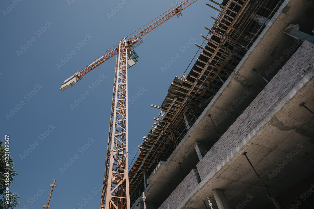 Construction site of multi-storey building with concrete slabs and columns. Men at work . Construction site of multi-storey building with concrete slabs and columns. Men at work .
