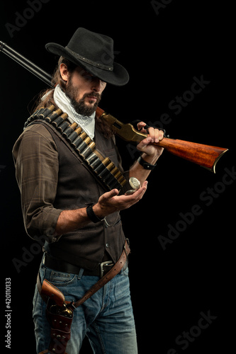 Cowboy with guns. Studio shooting