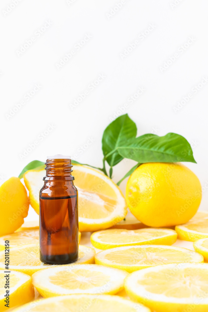 Lemon oil in a glass bottle. The use of citrus as an alternative medicine, aromatherapy, massage and relaxation. Lemon oil in a glass bottle. The use of citrus as an alternative medicine, aromatherapy, massage and relaxation.