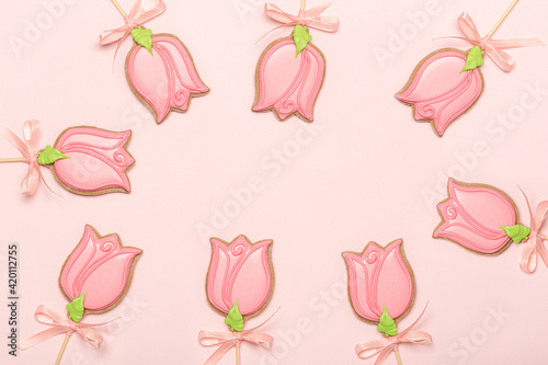 Gingerbread cookies in the shape of a tulip flowers on a pink background