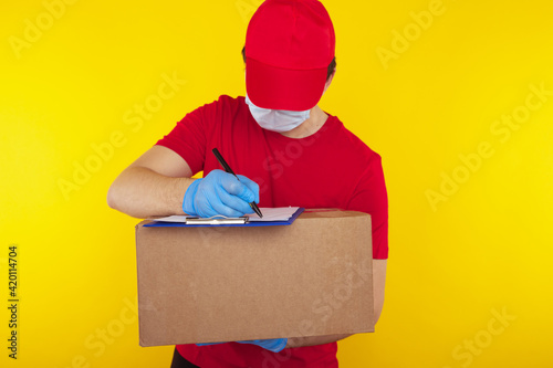 Delivery man holding cardboard boxes in medical rubber gloves and mask. copy space. Fast and free Delivery transport . Online shopping and Express delivery . Quarantine .