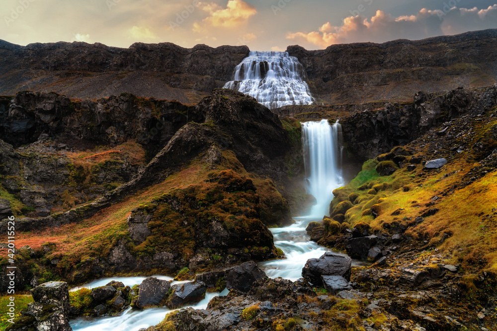 Dynjandi waterfall with tiered waterfalls in the foreground. Shot during early morning sunrise during autumn. Long Exposure Dynjandi waterfall with tiered waterfalls in the foreground. Shot during early morning sunrise during autumn. Long Exposure