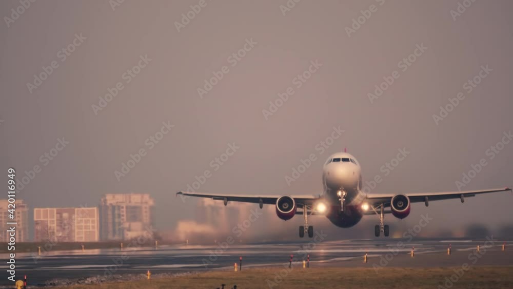 Airplane (aircraft) takes-off (taking off) at sunset