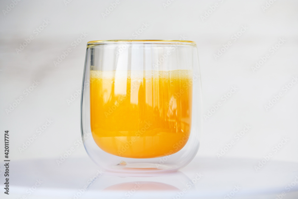 Transparent glass of fresh orange fruit juice Transparent glass of fresh orange fruit juice