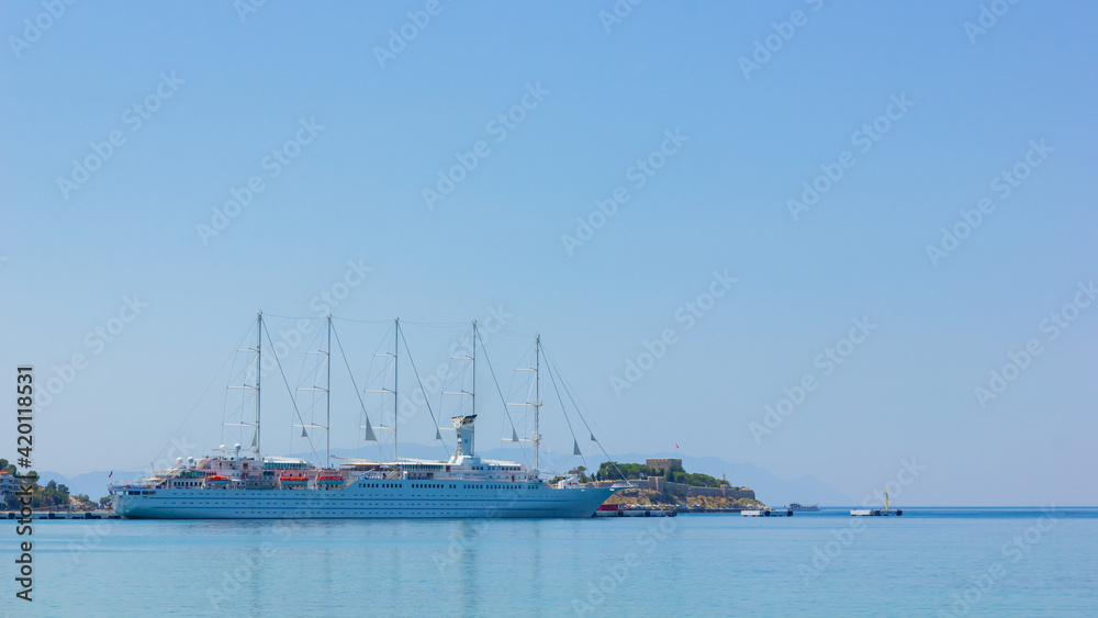 Holiday cruise liner in the port of Kusadasi, Turkey. View of the cruise ship docked in the resort town. Sea recreation concept