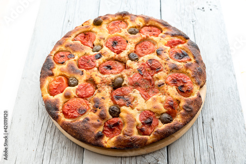 Focaccia typical of Bari Italy with tomatoes and olive photo