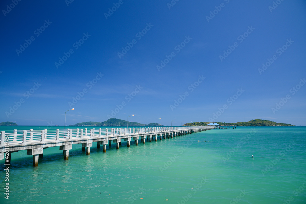 Concrete walk bridge across the sea with the blue sky at rawai beach, phuket Thailand