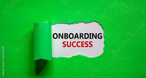 Onboarding success symbol. Words 'Onboarding success' appearing behind torn green paper. Beautiful green background. Business, onboarding success concept, copy space.