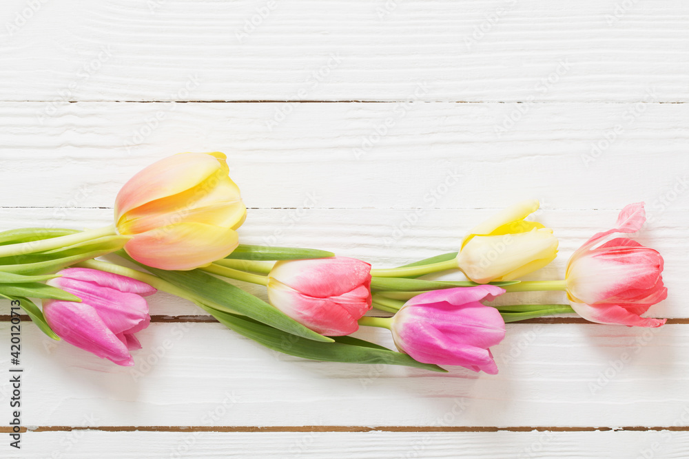 beautiful tulips on white wooden background