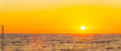 Orange sunset over sea. Bright sun over the sea horizon. Concept  vacation and relax