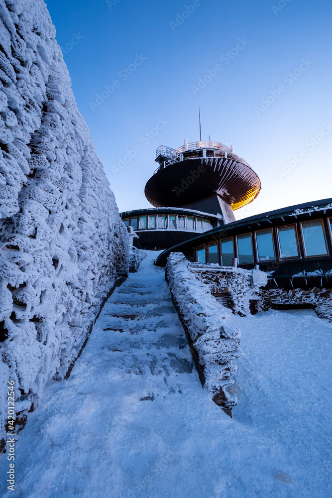 peak of Sniezka mountain at sunset in winter in the Karkonosze Mountains in Poland