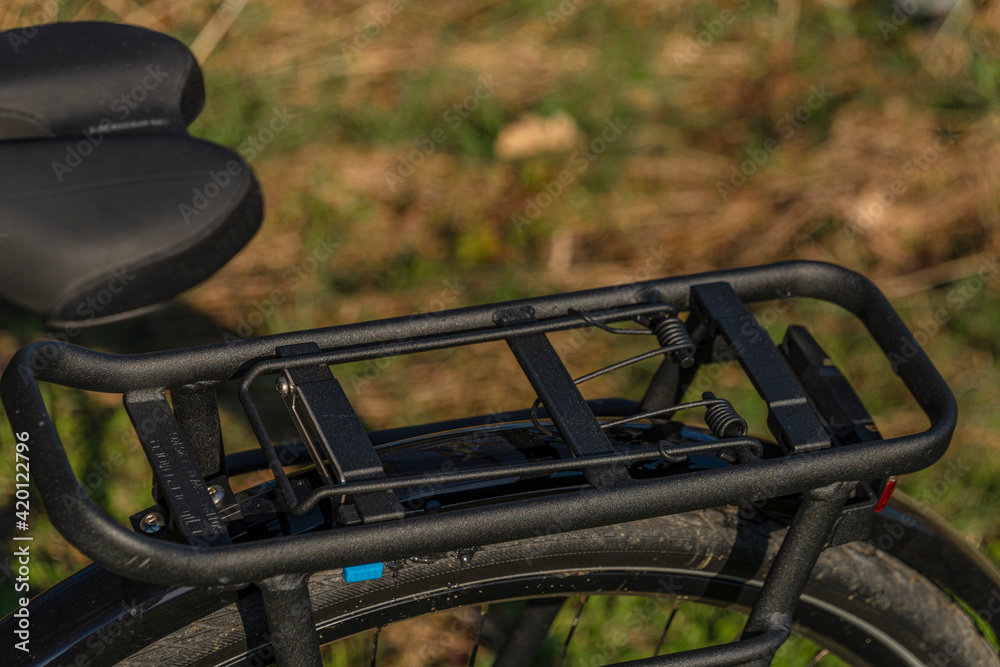 Black and gray electric bicycle in sunrise morning time on frosty field Black and gray electric bicycle in sunrise morning time on frosty field