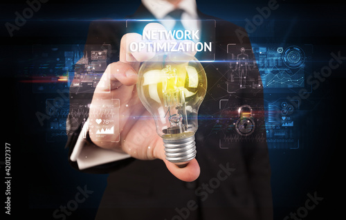 Businessman holding a light bulb, online security concept