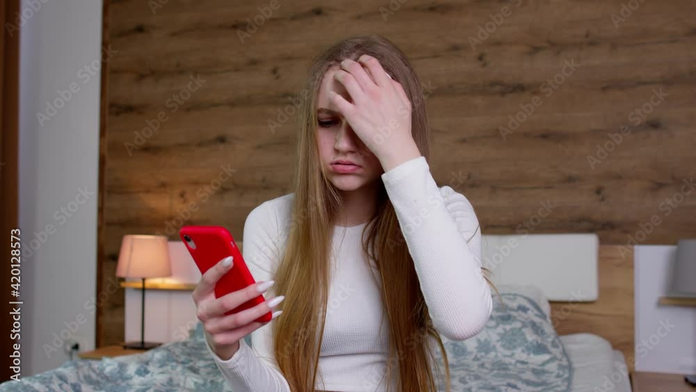 Sad upset dissatisfied irritated girl reading bad news on mobile phone, say no i do not need it Sad upset dissatisfied irritated girl reading bad news on mobile phone, say no i do not need it