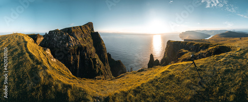 Aerial drone panorama view on Faroe Islands Suduroy todwards Beinisvord during sunset.