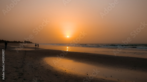 African beach orange sunset. People   community get together at the evening time. Kotu beach  The Gambia