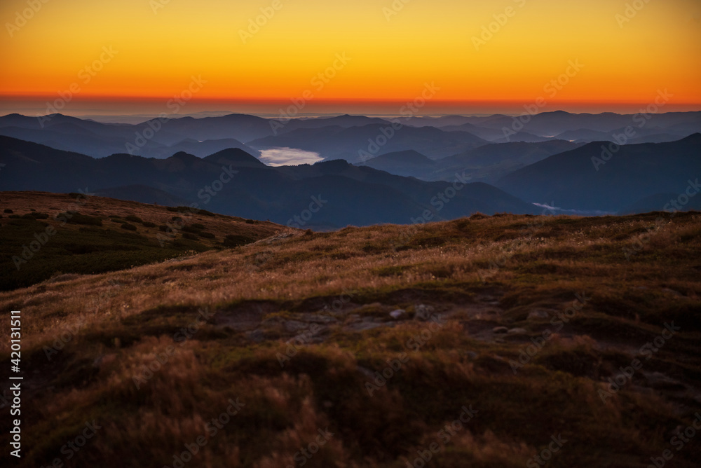 Scenic view of summer sunset over mountain peaks