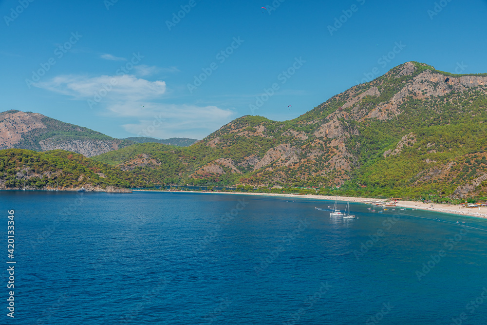 Beautiful view of sea coast in Oludeniz town in Mugla region, Turkey with turquoise water and mountains