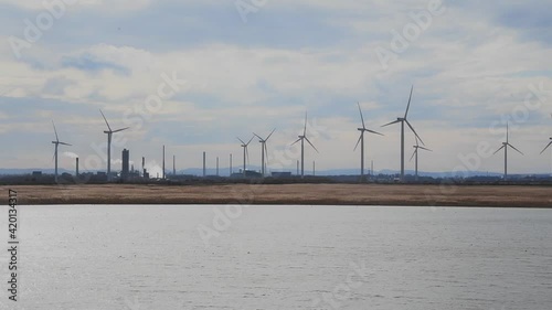Wind turbines on a wind farm at the end of the day giving the silhouette effect