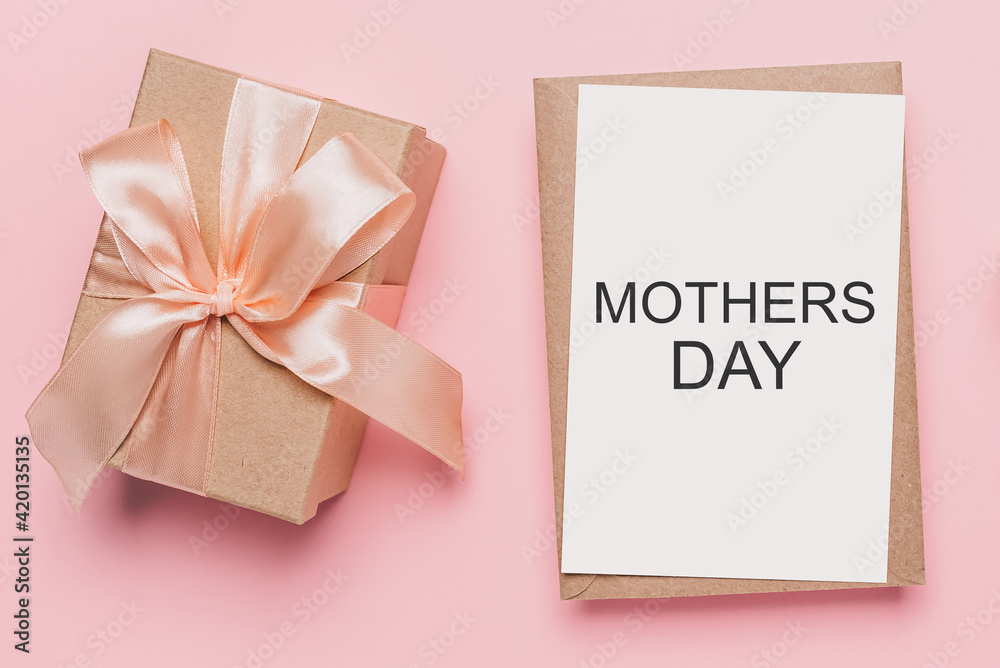 Gifts with note letter on isolated pink background, love and valentine concept with text mothers Day Gifts with note letter on isolated pink background, love and valentine concept with text mothers Day