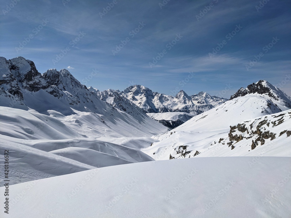 Panorama of the climber on the snow-capped mountain range. Ducan Glacier in Switzerland. Freeride in the mountains