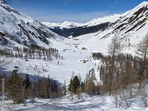 winter landscape in the side valley of davos. Mountain village of Sertig.Snow mountains with a river and beautiful trees