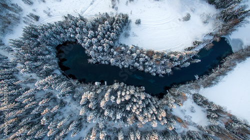 Aerial perspective (straight above) of a small fount in forests at winter. Kiikunlahde, Finland. photo