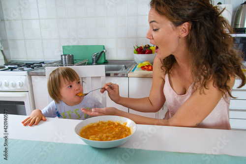 Mom trying everything to make his son to eat home coocked healthy food. Baby food.